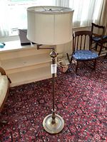 Full view of vintage brass floor lamp with fabric shade showing height and design