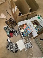 Full lot contents showing wallets, doll, books, frames in boxes, and dip chiller.