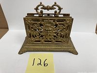 Front view showing ornate floral scroll design and handle