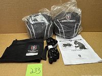 Complete kit displayed: two weighted pouches in plastic, mesh bag, clips, belt, manual