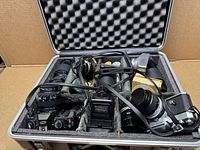 Open hard case with cameras, lenses and accessories