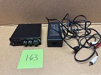 Front view of Douk Audio M1 Pro with power adapter and cables