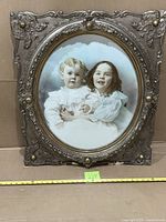 Front view of ornate frame and portrait