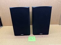 Front view of two Paradigm Titan V.3 bookshelf speakers with grilles