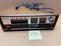 Front view showing controls, meters and attached power cord