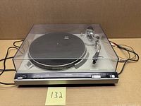 Turntable with dust cover closed and cabling visible