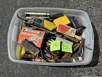 Tote of assorted tools showing quantity and variety