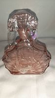 Pink vintage art deco depression glass bottle with stoppered top, showing geometric and angular design details.