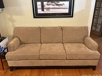 Full front view of the 3-seater taupe sofa showing overall condition and style