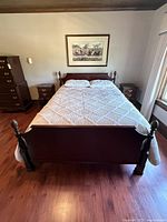 Front view showing full bed with posts, headboard and footboard