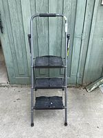 Front view of the Cosco 3 step ladder showing three wide plastic steps and steel frame.
