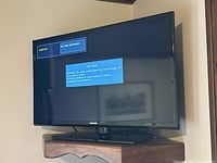 Front view of Samsung 32 inch LCD TV showing powered on screen with HDMI/DVI 'No Signal' message.