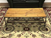 Overhead angle showing entire coffee table, highlighting the rectangular shape, plank arrangement, and iron frame forming the base and legs.