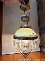 Front view of lamp fully extended showing shade, prisms and oil-font assembly