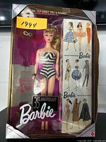 Full view of boxed 35th Anniversary Barbie Doll with packaging showing original 1959 Barbie design, stylish sunglasses accessory, and illustrations of vintage Barbie fashion models.