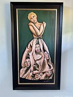 Full view of the framed oil painting showing a woman with expressive faces on her dress.