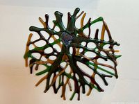 Abstract stained glass wall art piece with a web-like organic shape and mixed dark colors