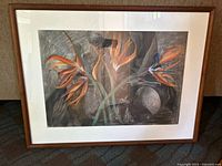 Framed chalk drawing of Birds of Paradise flowers on dark background