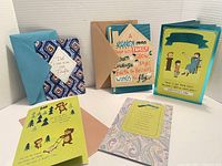 Photo showing 5 colorful Father's Day cards standing with matching envelopes, highlighting design and presentation.