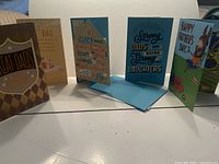 Photo of five unique Father's Day cards standing upright showing front covers and partial inside designs