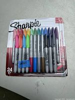 Photo of 24-pack Sharpie permanent markers new in blister pack showing assorted colors and packaging details.