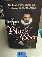 Photo of the front cover of 'The True History of the Black Adder' book showing title, author, and image of the character.