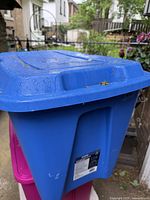 Blue large plastic storage tote with lid showing exterior and shape.