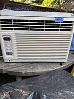 Front view of the LG window air conditioner showing vents and control panel with digital display.