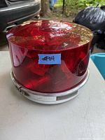 Front view of the vintage Dietz 211 warning roof light with red dome and metal base, showing general condition and size.