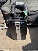 Danby Designer portable air conditioner with two flexible exhaust hoses, shown from the front with model tag visible on front panel.