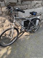 Side angle view of the entire silver GT Timberline bicycle showing frame, tires, saddle and handlebars.