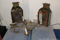 Overhead shot of two lanterns and chandelier on table showing full lot contents.