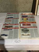 Four sleeves with two sheets each containing Corvette technical data cards featuring images and detailed car specs