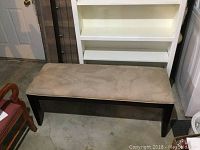 Photo of the wooden hall bench with cushioned beige microsuede top showing the bench from the front at an angle.