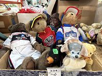 Box containing the plush toys including Boyds NASCAR bears and other plush figures.