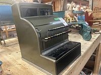 Side and front angle view showing the overall shape, key layout, and mechanical display.