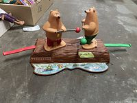 Full view of the Marx brand vintage bear bop toy showing two bear figurines on a log base with red and green ball sticks.