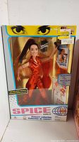 Front view of the Spice Girls Concert Collection Sporty Spice doll in original packaging showing the doll dressed in shiny orange and clear branding.