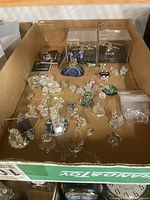 Overall lot of crystal figurines and metal models in cardboard box