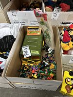 Overhead photo of box showing green TMNT van, multiple TMNT action figures, and packaged lunch bag.