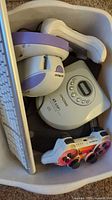 Bin with keyboards, mice, CD player, controllers visible