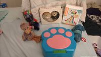 All items top view showing Blue's Clues box, Marvel figure, Ty plushes, boxed figurines, boxed rattle