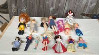 Group shot of all thirteen dolls laid on fabric