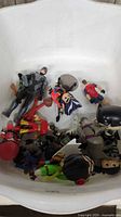Top view of assorted figures showing grey armoured hero, red and yellow hero, Link, black masked piece, reindeer, others