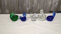 Front view of five glass animal figurines lined up