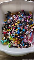 Tub containing large quantity of mixed Disney figurines