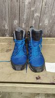 Front view of pair of blue and black The North Face boots