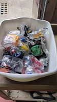 Bin containing multiple sealed McDonald’s and Burger King toys