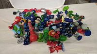 Pile of PJ Masks plastic figures on tabletop