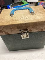 Carrying case for vinyl records closed, showing wear and age